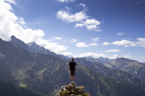 man standing on a cliff used under creative commons